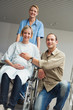 Pregnant woman in a wheelchair with a nurse and a man
