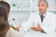 Pharmacist giving pills to a customer