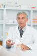 Pharmacist taking a prescription from the hand of a customer