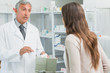 Male pharmacist talking to a woman