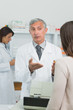 Pharmacist explaining something to a customer