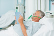 Male patient wearing an oxygen mask while holding a tactile tablet