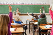 Back view of class raising hands