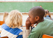 Boys whispering during lesson