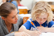 Teacher assisting one of her students