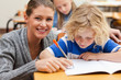 Smiling teacher helping one of her students