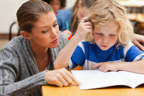 Photo: Teacher helping student with his exercises Teacher helping student with his exercises