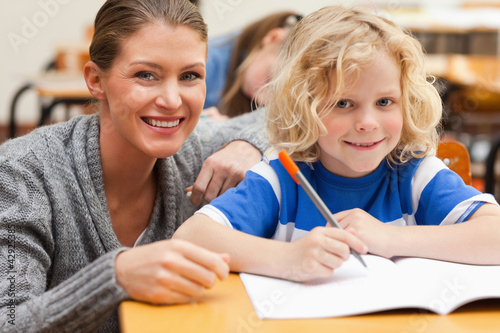 Photo: Student getting help from his teacher Student getting help from his teacher
