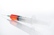 syringe with red fluid
