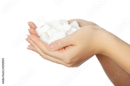 Photo: Woman's hands full of sugar cubes. Woman's hands full of sugar cubes.