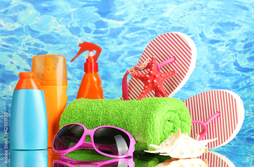 Photo: bright beach accessories, on blue sea background bright beach accessories, on blue sea background