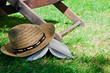 Book and straw hat on grass