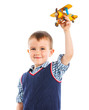 Foto: Cute little boy playing with a toy airplane Cute little boy playing with a toy airplane
