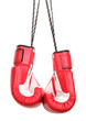 Red boxing gloves hanging isolated on white