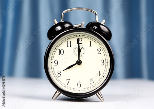 Photo: Alarm clock on a light background Alarm clock on a light background