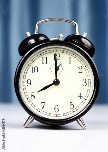 Photo: Alarm clock on a light background Alarm clock on a light background
