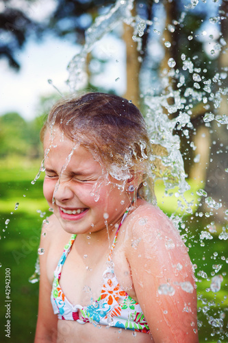 Photo: girl having fun outdoor with water girl having fun outdoor with water