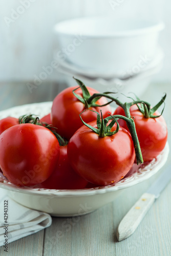 Photo: Tomatoes on the vine in a bowl Tomatoes on the vine in a bowl