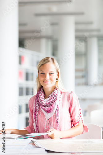 Photo: in the library - pretty female student with books in the library - pretty female student with books