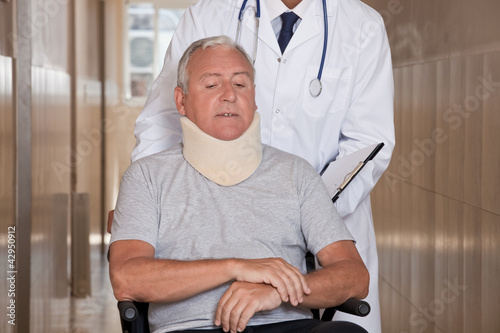 Photo: Doctor with Patient in Wheelchair Doctor with Patient in Wheelchair