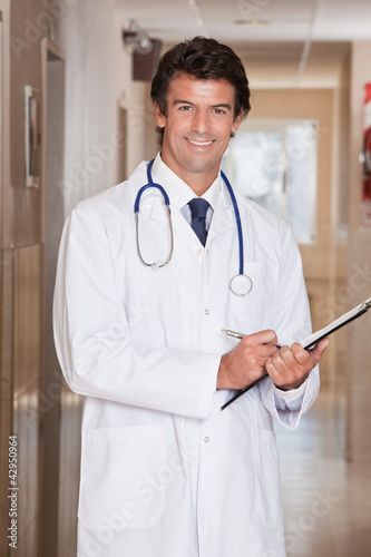 Foto: Male Doctor Standing with Folder Male Doctor Standing with Folder