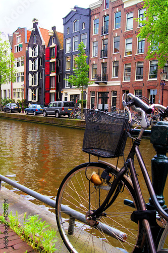 Photo: Bicycle along the canals of Amsterdam, The Netherlands Bicycle along the canals of Amsterdam, The Netherlands