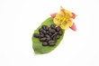 Photo: Coffee beans on a leaf with yellow and pink flower Coffee beans on a leaf with yellow and pink flower
