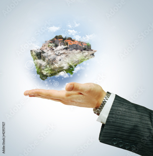 Foto: Flying island on businessman's hand Flying island on businessman's hand