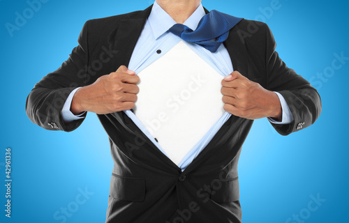 Photo: Businessman showing a superhero suit Businessman showing a superhero suit