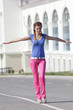 Young woman  walking along the carriageway