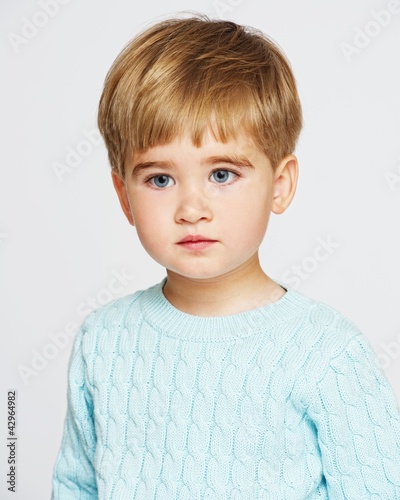 Photo: Pensive baby boy in blue pullover Pensive baby boy in blue pullover