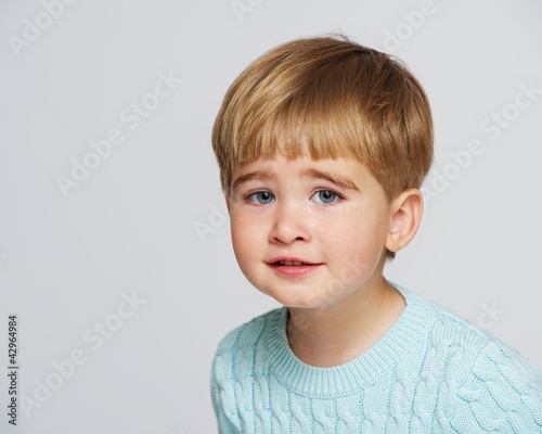 Photo: Funny baby boy in blue pullover portrait Funny baby boy in blue pullover portrait