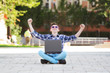Young man with notebook enjoying success