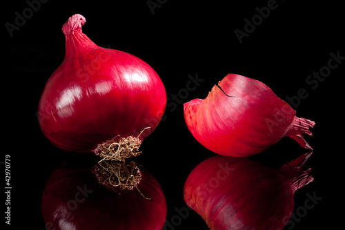Photo: Piurple onion isolated on black. Piurple onion isolated on black.