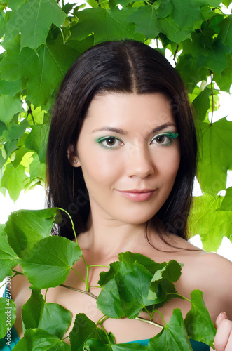 Photo: Beautiful woman with spring green leaves Beautiful woman with spring green leaves