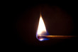 Burning match on a black background