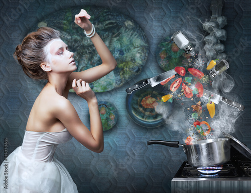 Photo: Beautiful emotional woman in kitchen interior cooking. Art Beautiful emotional woman in kitchen interior cooking. Art