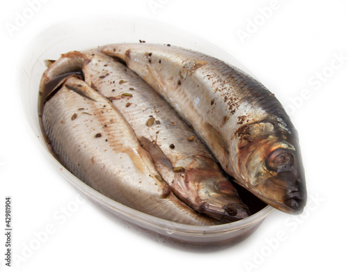 Photo: spicy salted herring on a white background spicy salted herring on a white background
