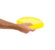 Photo: Closeup on flying disc in male hand isolated on white Closeup on flying disc in male hand isolated on white