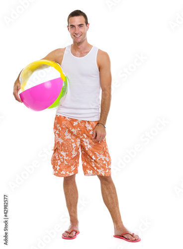 Photo: Resting on vacation smiling young man with beach ball Resting on vacation smiling young man with beach ball