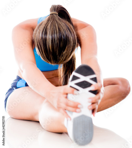 Foto: Athletic woman stretching Athletic woman stretching