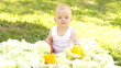 Newborn in the cabbage and vegetables outdoors