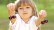 Child playing with cherries
