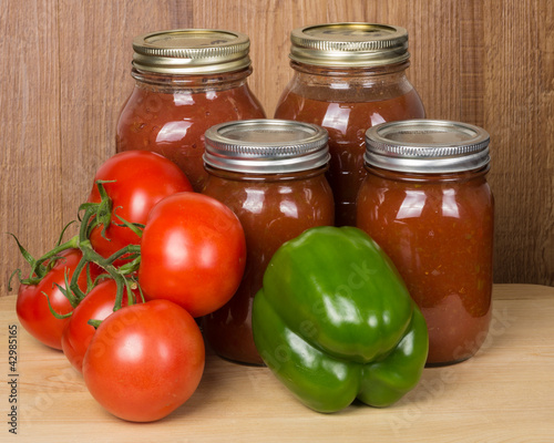 Photo: Tomato sauce in jars with tomatoes and peppers Tomato sauce in jars with tomatoes and peppers