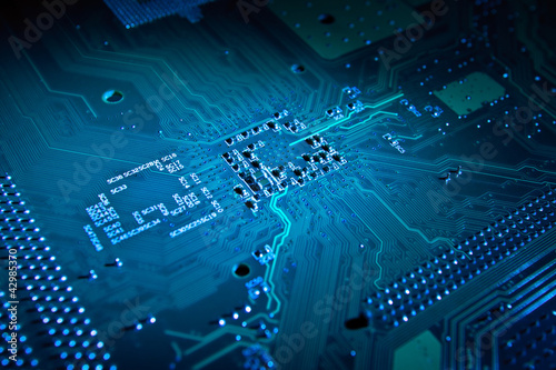Photo: Blue glowing computer motherboard abstract background Blue glowing computer motherboard abstract background