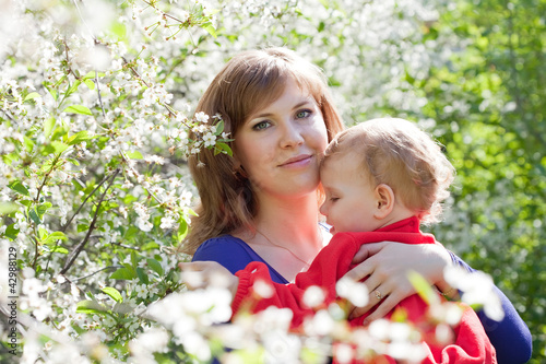 Photo: mother and baby in blossoming garden mother and baby in blossoming garden