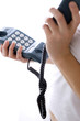 A pair of hands picking up the receiver of the phone