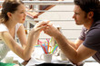 Side shot of a couple holding a cup together
