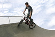 A boy cycling in a skateboard park 