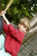 Boy playing with a swinging tyre 